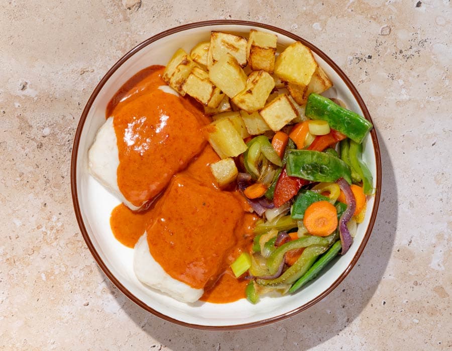 Merluza con pil pil de piquillos, patatas y verduras variadas